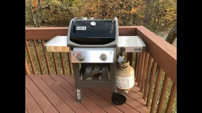 a grill sitting on a deck on a porch at Beautiful Windham Chalet 2 minutes to the Mountain in Windham