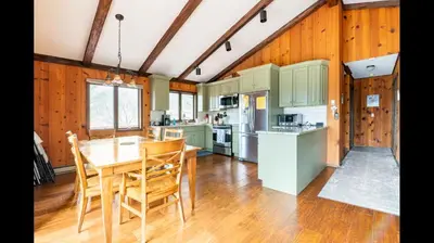 a kitchen with a table and chairs in a room at Beautiful Windham Chalet 2 minutes to the Mountain in Windham