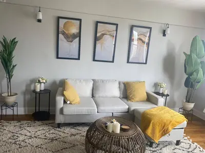 a living room with a couch and a table at Stylish- 1 bed room spacious APT in Corona