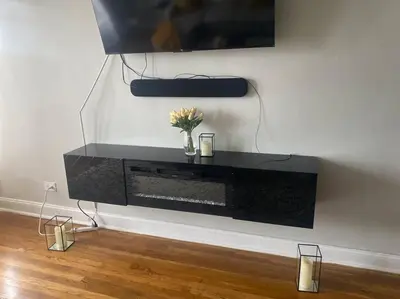 a black entertainment center against a wall with a tv at Stylish- 1 bed room spacious APT in Corona