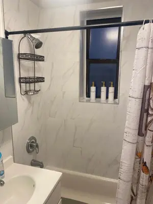 a bathroom with a shower and a sink at Stylish- 1 bed room spacious APT in Corona