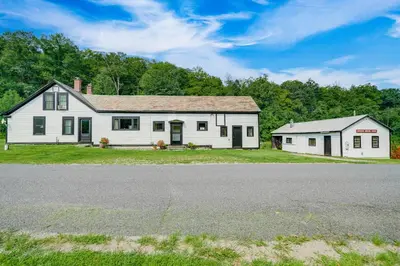 an old white house with a barn and a road at Hawley Home with Deck and Mtn Views Swim, Ski and More! in Hawley