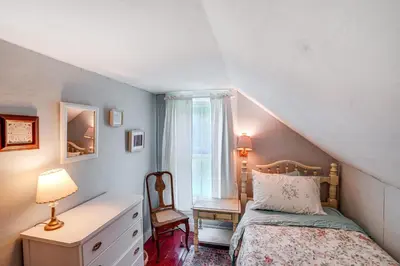 a bedroom with a bed and a dresser and a window at Hawley Home with Deck and Mtn Views Swim, Ski and More! in Hawley
