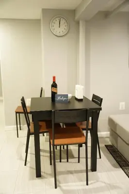 a black dining room table with a bottle of wine at Cozy 2 Bedroom In A Lovely Forest Hills Neighborhood in Parkside