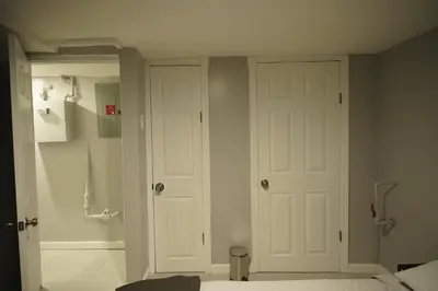a bathroom with a white door in a room at Cozy 2 Bedroom In A Lovely Forest Hills Neighborhood in Parkside