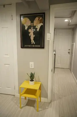 a room with a yellow table and a picture on the wall at Cozy 2 Bedroom In A Lovely Forest Hills Neighborhood in Parkside