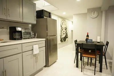 a kitchen with a table and a refrigerator at Cozy 2 Bedroom In A Lovely Forest Hills Neighborhood in Parkside