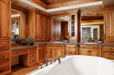 a kitchen with wooden cabinets and a large white sink at Private 37 Acre Lake Estate On 164 Acres - 11 Br in Highland