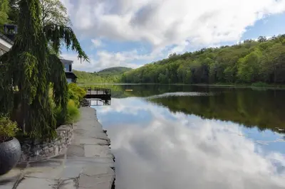 a river with a reflection of the sky in the water at Private 37 Acre Lake Estate On 164 Acres - 11 Br in Highland