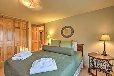 a bedroom with a green bed with towels on it at Catskill Ski Mountain Retreat with Private Pool in Big Indian