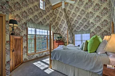 a bedroom with a large bed with floral wallpaper at Catskill Ski Mountain Retreat with Private Pool in Big Indian