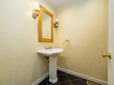 a bathroom with a sink and a mirror at Green Utopia in New Canaan
