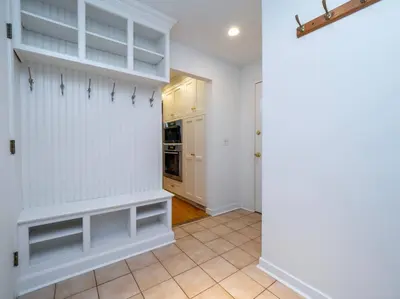 a kitchen with white walls and white shelves at Green Utopia in New Canaan