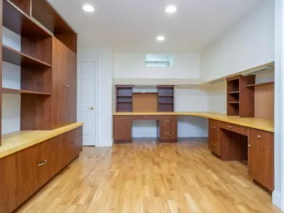 a large room with wooden cabinets and a hardwood floor at Green Utopia in New Canaan