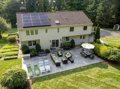 an aerial view of a house with solar panels on it at Green Utopia in New Canaan