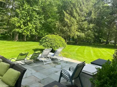 a group of lawn chairs sitting on a patio at Green Utopia in New Canaan