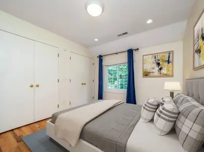 a bedroom with a large bed and a window at Green Utopia in New Canaan