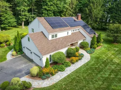 an aerial view of a house with solar panels on the roof at Green Utopia in Wilton