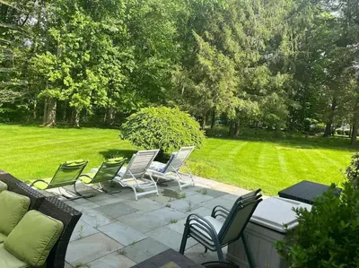 a group of lawn chairs sitting on a patio at Green Utopia in Wilton