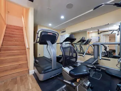 a gym with several treadmills and stairs in a room at Green Utopia in Wilton