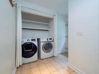 a laundry room with a washer and dryer in it at Green Utopia in Wilton
