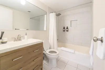 a white bathroom with a toilet and a sink at Convention Center 1BR Condo Downtown Hartford and GYM in Hartford