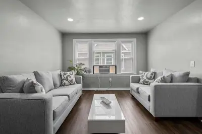 a living room with two couches and a table at Freshly Redone & Newly Furnished! A MUST SEE! in New Britain