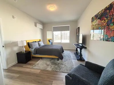 a bedroom with a bed and a couch at The Westchester Experience in White Plains