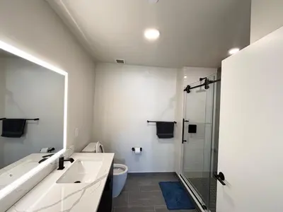 a bathroom with a toilet and a sink and a shower at The Westchester Experience in White Plains