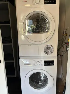 a washing machine and a washer in a room at The Westchester Experience in White Plains