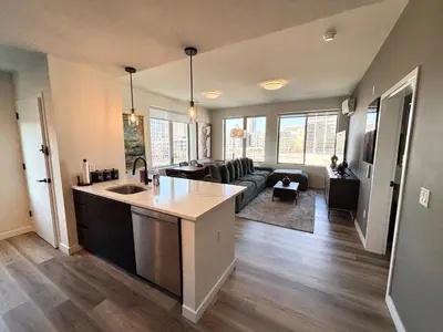 a large kitchen and living room with a couch at The Westchester Experience in White Plains