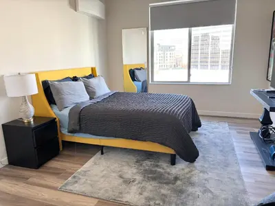 a bedroom with a large bed and a window at The Westchester Experience in White Plains