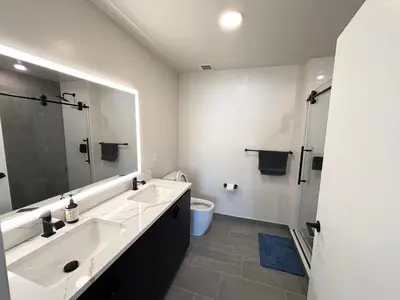 a bathroom with a sink and a toilet and a mirror at The Westchester Experience in White Plains
