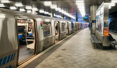 a subway train is parked in a subway station at One Grove in Jersey City in Jersey City