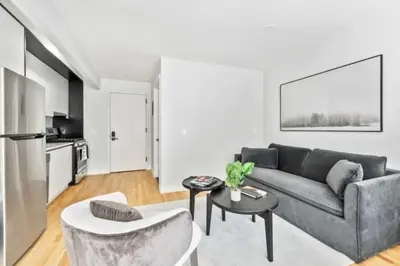 a living room with a couch and a table at Luxe Studio with Charming Juliet Balcony in New York