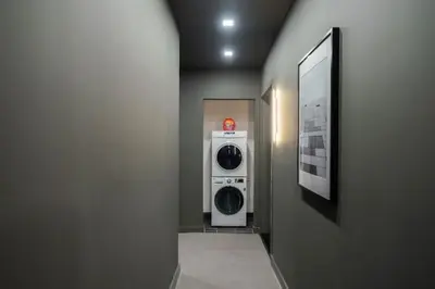 a hallway with a washer and dryer in a room at Luxe Studio with Charming Juliet Balcony in New York