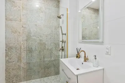 a bathroom with a sink and a shower at Studio w Charming Juliet Balcony in Upper East in New York