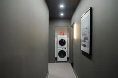 a hallway with a washer and dryer in a room at Studio w Charming Juliet Balcony in Upper East in New York