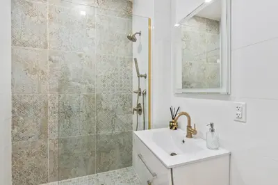 a bathroom with a sink and a shower at Studio w Charming Juliet Balcony in Upper East in New York