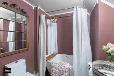 a bathroom with a white shower curtain and a toilet at Vermont Lake Whitingham Mount Snow Area Apartment in Jacksonville