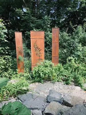 a group of three metal posts in a garden at Vermont Lake Whitingham Mount Snow Area Apartment in Jacksonville