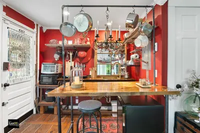 a kitchen with red walls and a table with chairs at Vermont Lake Whitingham Mount Snow Area Apartment in Jacksonville