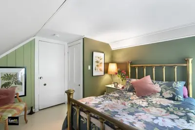 a bedroom with a bed with a floral bedspread at Vermont Lake Whitingham Mount Snow Area Apartment in Jacksonville