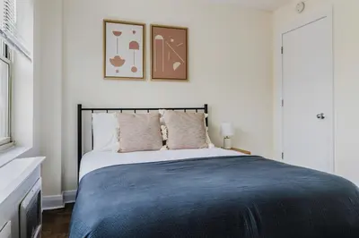 a bedroom with a large bed with two pillows at Blueground Murray Hill gym lounge wd NYC-1565 in New York