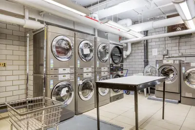 a laundry room with a bunch of washing machines at Blueground Murray Hill gym lounge wd NYC-1565 in New York