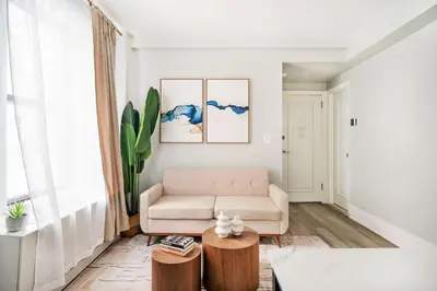 a living room with a couch and a table at 73-308 New 1BR 1Bth UWS Doorman Gym in New York