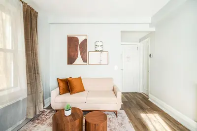 a living room with a couch and a table at 73-608 New 1BR 1Bth UWS Doorman Gym in New York