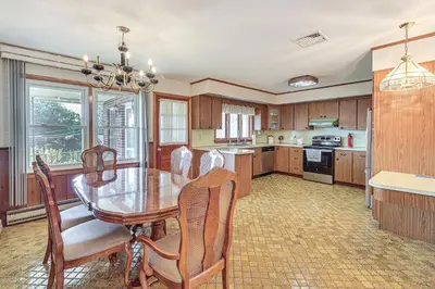 a kitchen with a dining room table and chairs at Watertown Home with Yard 1 Mi to Echo Lake Park! in Watertown