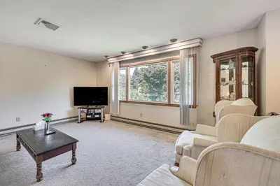a living room with a couch and a tv at Watertown Home with Yard 1 Mi to Echo Lake Park! in Watertown