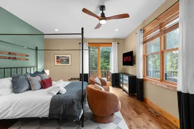a bedroom with a bed and a ceiling fan at Luxury Chalet, Firepit, Sauna, Pet Friendly, 5 mins to Windham Mtn resort in Windham